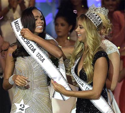 Genesis Davila, the original winner of Miss Florida USA 2017 is sashed by Brie Gabrielle, Miss Florida USA 2016